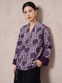 Model wearing the purple floral wrap jacket with a black skirt