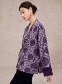 Side view of the purple floral jacket showing its relaxed shape and long sleeve