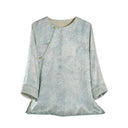 Front product view of a light blue Hualuo jacquard silk blouse with a round neck, asymmetric buttons and three-quarter sleeves
