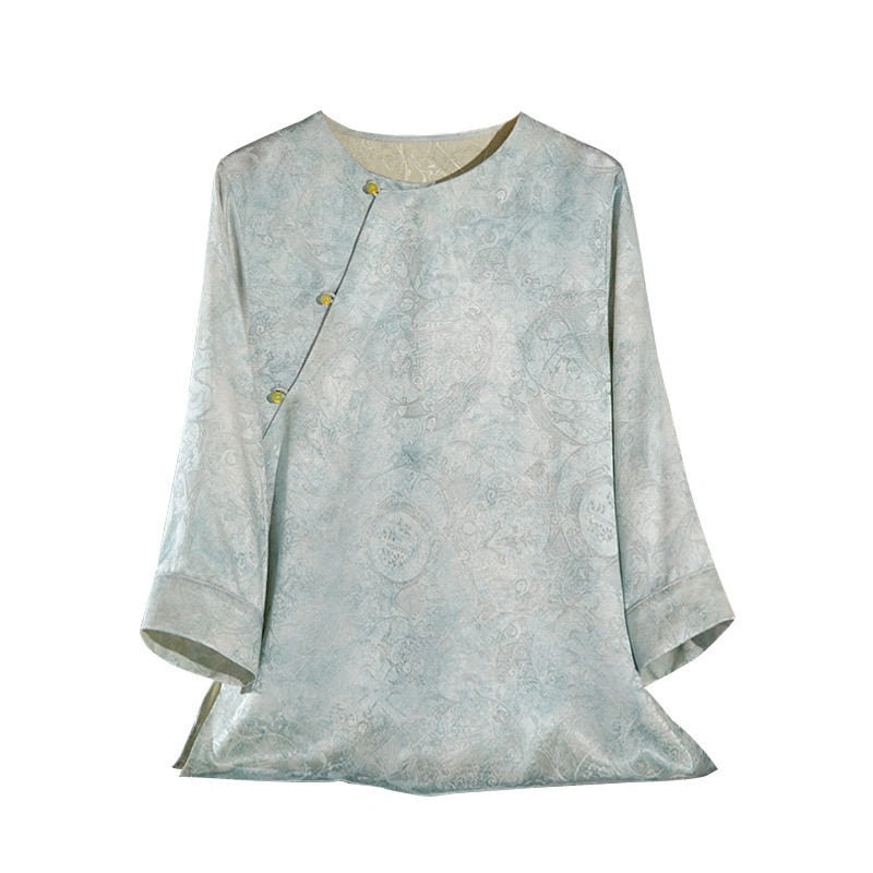 Front product view of a light blue Hualuo jacquard silk blouse with a round neck, asymmetric buttons and three-quarter sleeves