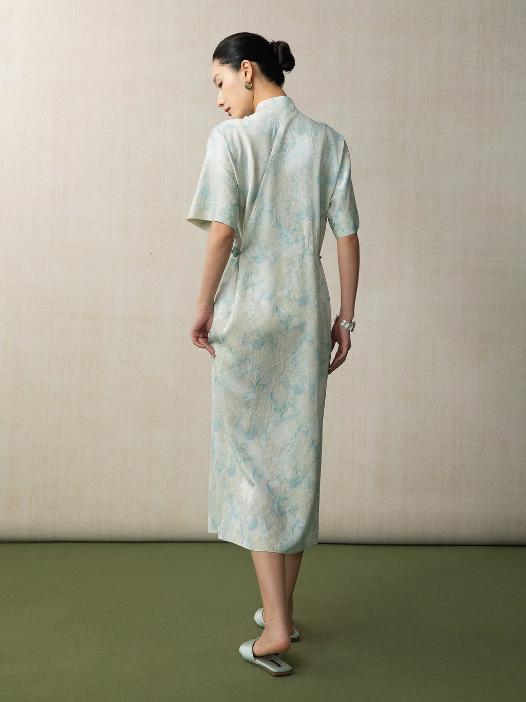 Back view of a light blue jacquard Chinese style midi dress