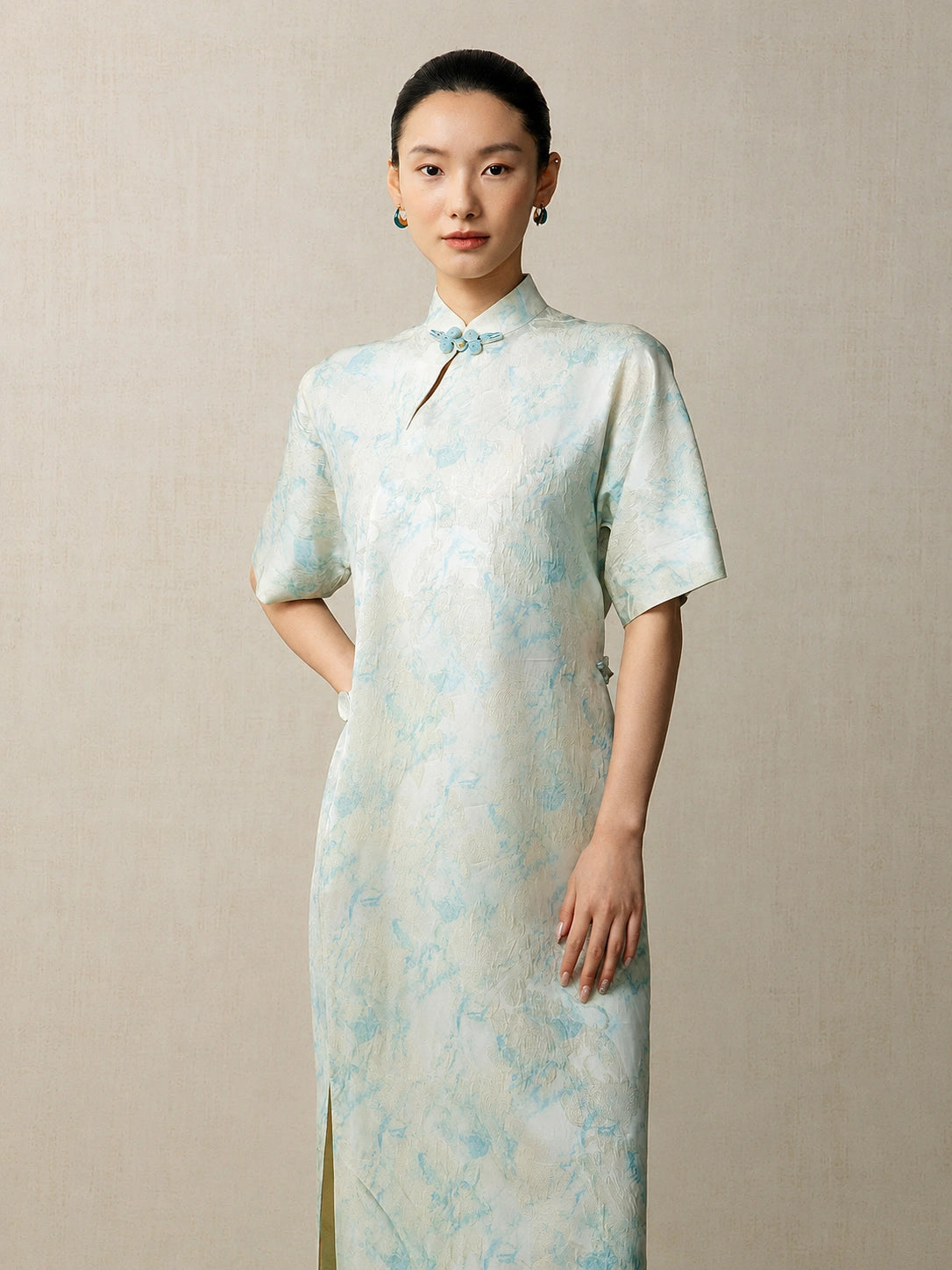 Front view of a light blue jacquard mandarin collar dress for women by Gambiered Silk