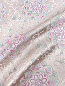 Draped jacquard fabric showing its soft sheen and pastel floral pattern.