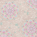 Macro view of pink and mint floral medallions on the vest’s pale pink jacquard fabric.