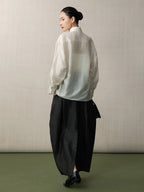 Back view of a women's lyocell linen blend blouse with a loose fit and mandarin collar.