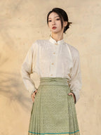 Front view of a Chinese-style jacquard blouse with relaxed fit and Mandarin collar.