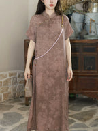 Close-up of the mauve silk-blend dress showing the stand collar and tone-on-tone floral texture