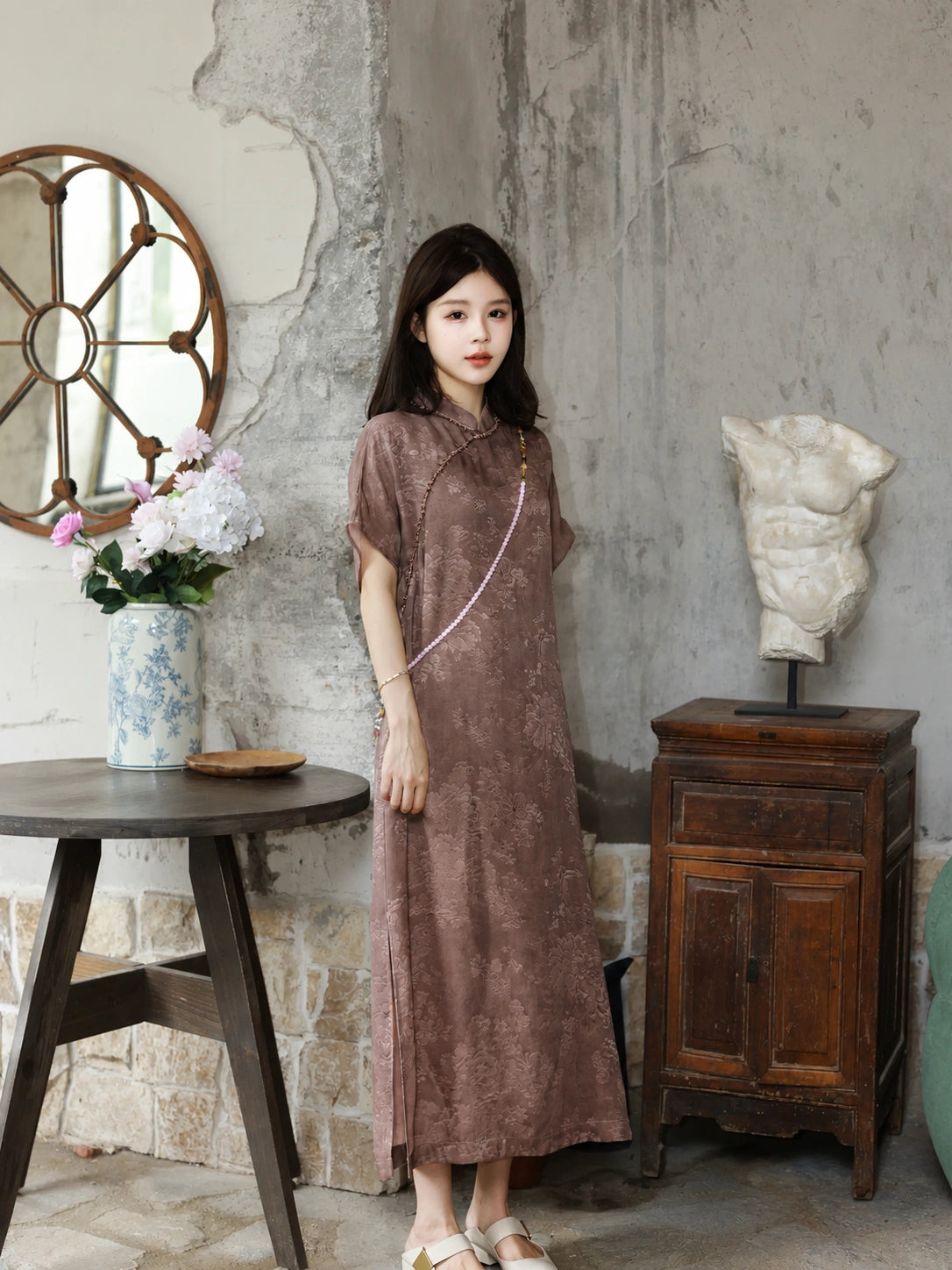 Model standing in a mauve silk-blend dress with regular sleeves and a relaxed H-line fit