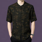 Men's black 100% mulberry silk short-sleeve shirt featuring a traditional mandarin collar, frog button placket, and copper-gold bamboo and cloud pattern.