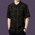 Front view of the men's silk shirt with a relaxed straight cut, showcasing the elegant contrast between the dark base and the subtle bronze-toned pattern.