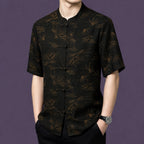  Front view of the men's silk shirt with a relaxed straight cut, showcasing the elegant contrast between the dark base and the subtle bronze-toned pattern.
