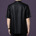 Back view of the men's black silk shirt showcasing the consistent, deeply textured crackle finish that runs across the entire garment.
