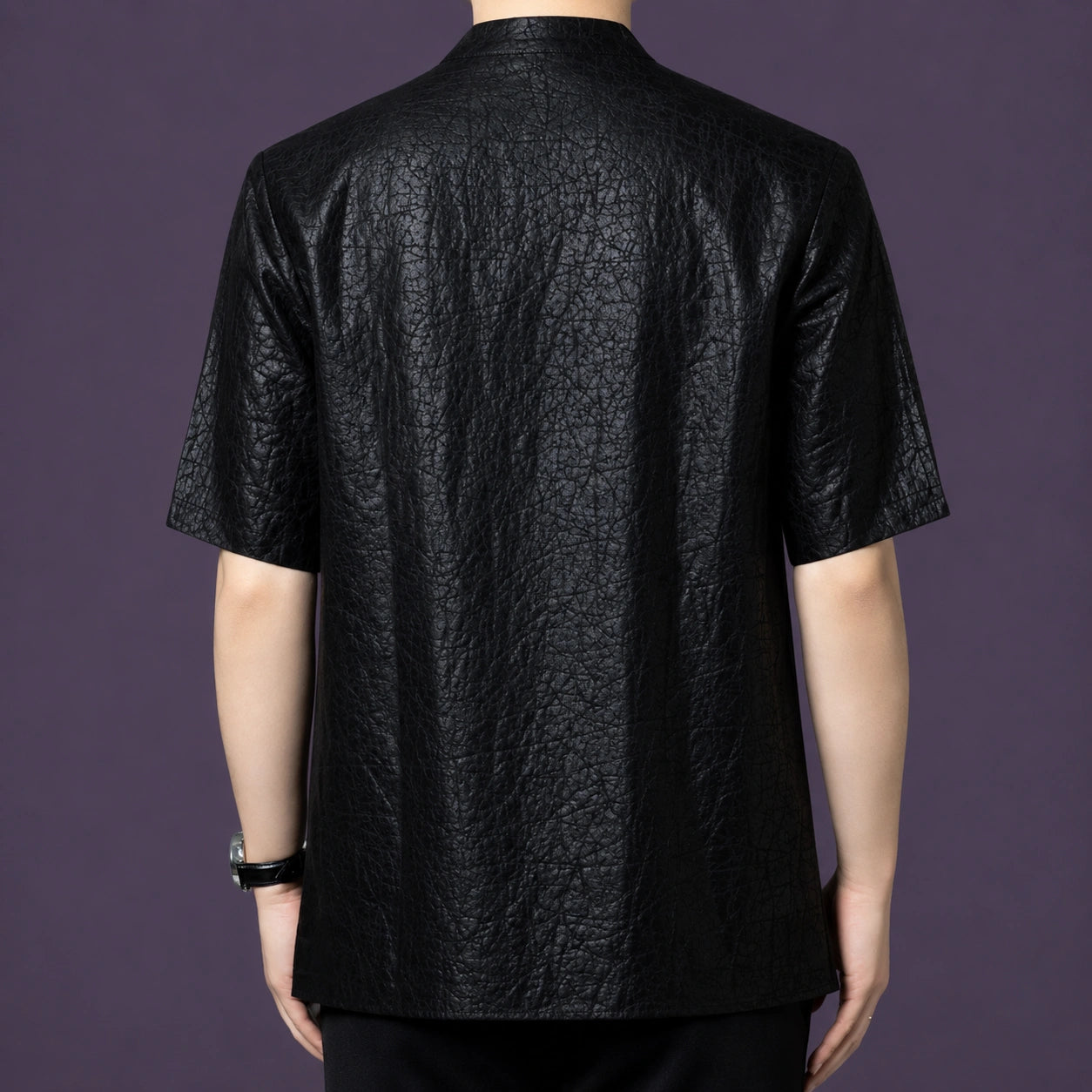 Back view of the men's black silk shirt showcasing the consistent, deeply textured crackle finish that runs across the entire garment.