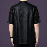 Back view of the men's black silk shirt showcasing the consistent, deeply textured crackle finish that runs across the entire garment.