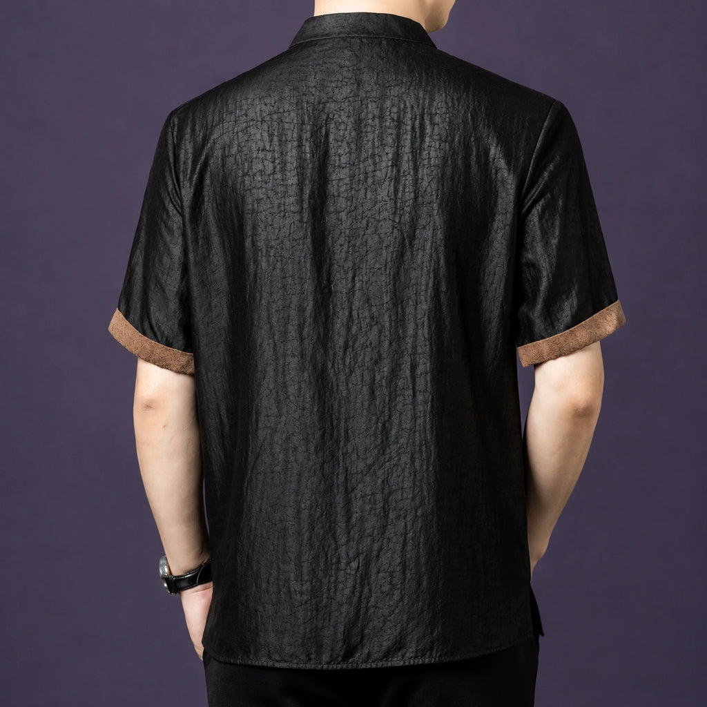 Back view of the black crackle silk shirt, showcasing the consistent texture and the brown contrast binding on the cuffs.