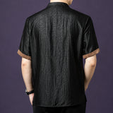 Back view of the black crackle silk shirt, showcasing the consistent texture and the brown contrast binding on the cuffs.
