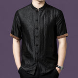 Men's black 100% mulberry silk short-sleeve shirt with a crackle texture, stand collar, front patch pockets, and contrasting brown cuffs.