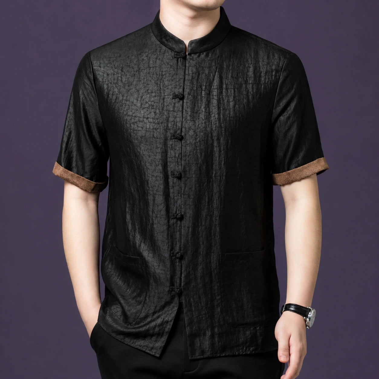 Men's black silk shirt with a relaxed fit, two large patch pockets, and a subtle contrast cuff detail that breaks up the all-black look.