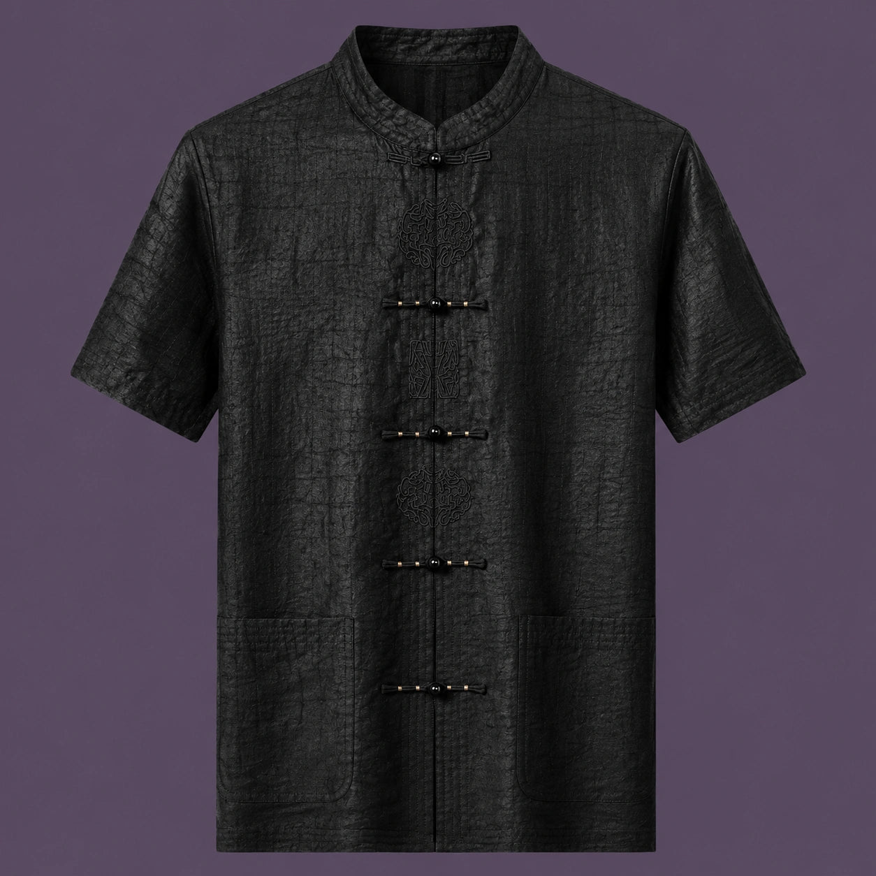 Flat lay of the men's black silk short-sleeve shirt, showing the stand collar, embroidered frog buttons, and three front pockets.