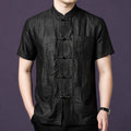Men's black 100% mulberry silk short-sleeve shirt featuring a textured crackle finish, a stand collar, and delicate embroidered frog buttons down the front placket.