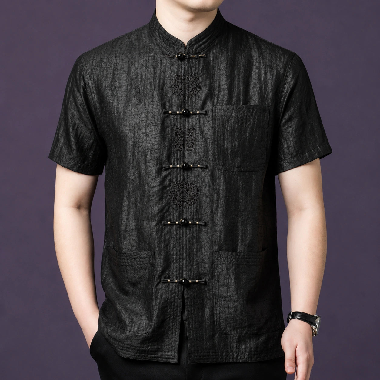 Men's black 100% mulberry silk short-sleeve shirt featuring a textured crackle finish, a stand collar, and delicate embroidered frog buttons down the front placket.