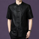 Men's black 100% mulberry silk short-sleeve shirt with a distinctive crackle leather-like texture, a stand collar, and traditional frog buttons.