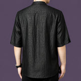 Back view of the black silk shirt, highlighting the consistent crackled texture across the back and the relaxed, straight silhouette.