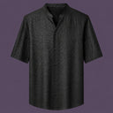 Flat lay of the men's black silk short-sleeve shirt, featuring a stand collar with a V-slit and a clean button-down front.