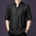 Men's black 100% mulberry silk short-sleeve shirt with a relaxed fit, a stand collar with a subtle V-opening, and a classic button placket.