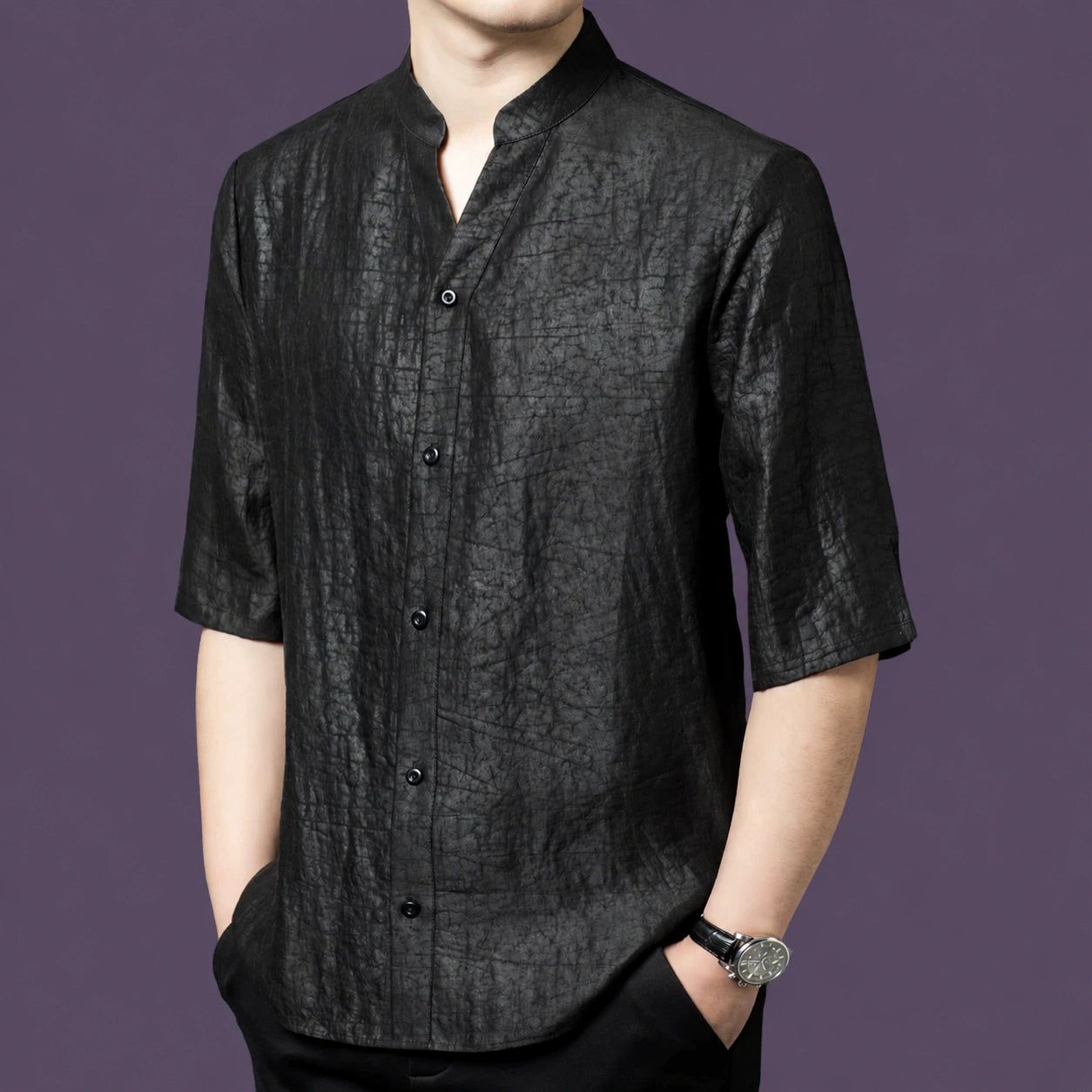 Front view of the minimalist black silk shirt, showcasing the distinct crackle texture and the clean, unlined button-down front.