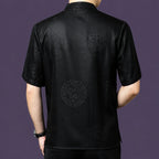 Back view of the black jacquard silk shirt, showing the scattered floral medallions that catch the light subtly against the geometric background.