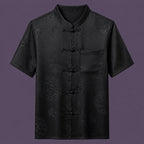 Flat lay of the men's short-sleeve silk shirt, featuring a stand collar, six frog buttons, and a single patch pocket.