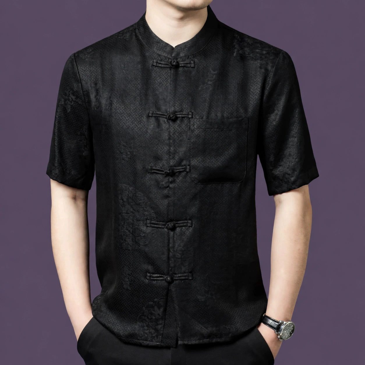 Men's black 100% mulberry silk short-sleeve shirt with a subtle jacquard pattern, a stand collar, traditional frog buttons, and a single chest pocket.
