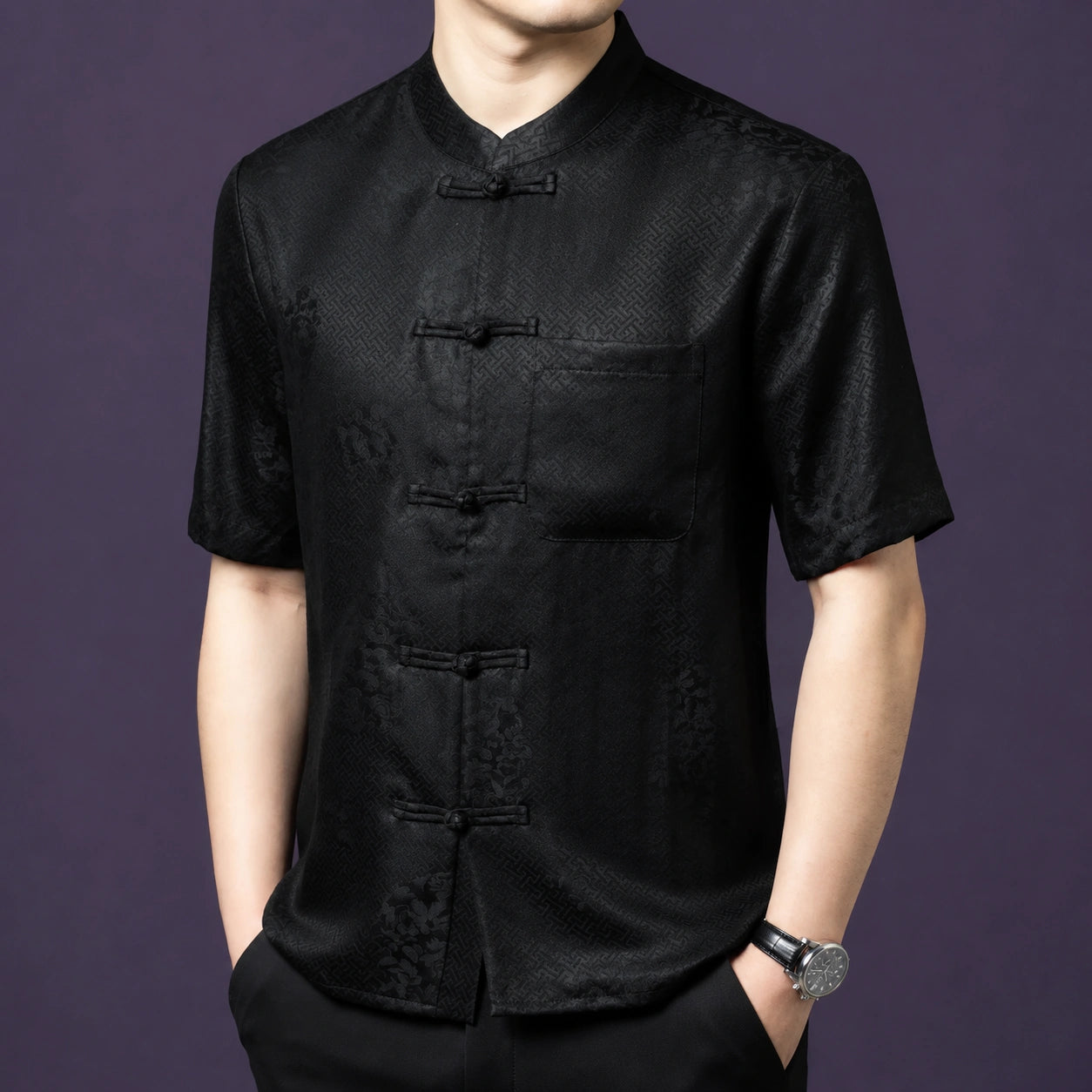 Front view of the black silk top, highlighting the geometric weave texture and the classic frog button placket.