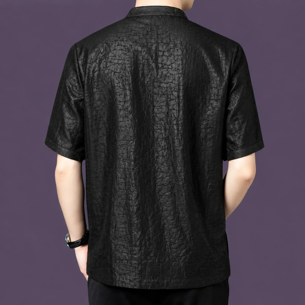 Back view of the black silk shirt, showcasing the straight, relaxed silhouette and the striking crackle pattern that continues across the back panel.