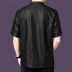 Back view of the black silk shirt, showcasing the straight, relaxed silhouette and the striking crackle pattern that continues across the back panel.
