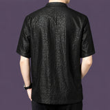 Back view of the black silk shirt, showcasing the straight, relaxed silhouette and the striking crackle pattern that continues across the back panel.