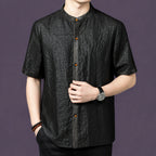 Front view of a black textured silk shirt with a clean button-down placket and a relaxed straight cut.