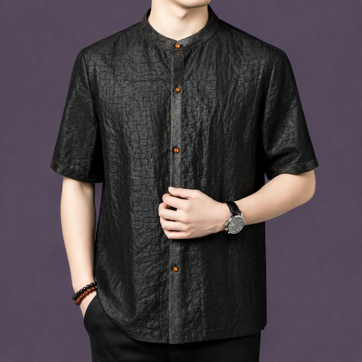 Front view of a black textured silk shirt with a clean button-down placket and a relaxed straight cut.