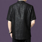 Back view of the men's black silk shirt, showing the straight, relaxed silhouette and the continued cracked texture across the back panel.