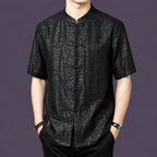 Men's black 100% mulberry silk short-sleeve shirt with a stand collar and contrasting purple-red frog button closures, featuring a distinct cracked texture.