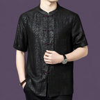 Front view of a black silk short-sleeve shirt with a traditional Chinese stand collar and a row of color-contrast knot buttons.