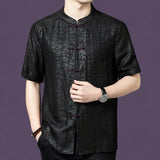 Front view of a black silk short-sleeve shirt with a traditional Chinese stand collar and a row of color-contrast knot buttons.