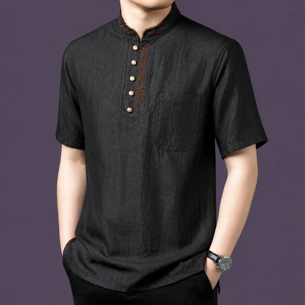Close-up view of the black silk henley top, highlighting the four-button placket and single chest pocket.