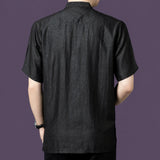 Back view of the black silk henley shirt, showcasing the relaxed drape and simple, clean back construction.
