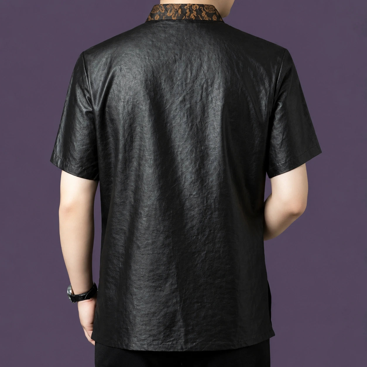 Back view of the black silk shirt, showing the clean, relaxed drape and the continuation of the bronze jacquard collar detail at the nape.