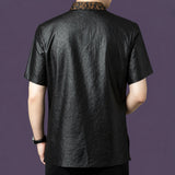 Back view of the black silk shirt, showing the clean, relaxed drape and the continuation of the bronze jacquard collar detail at the nape.