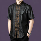 Front view of a black silk shirt with a textured body and a detailed embroidered jacquard panel running down the center.