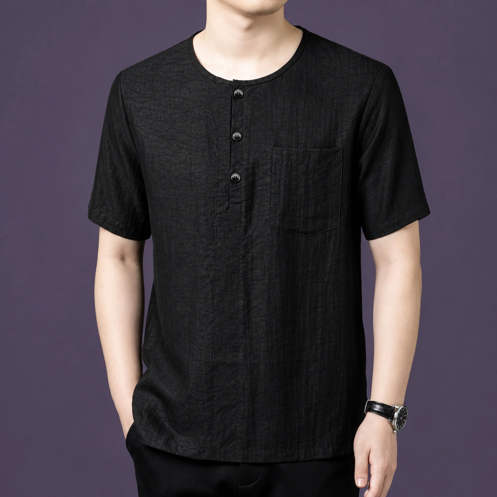 Front view of the black silk short-sleeve top, highlighting the textured crinkled finish and the relaxed, straight cut.
