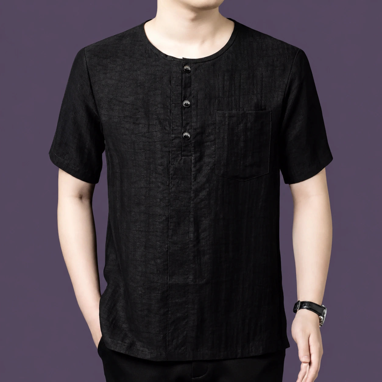 Men's black silk henley with a round neckline and left chest pocket, designed with a simple, breathable silhouette.